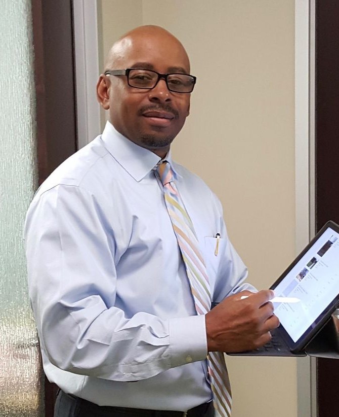 Universal Inspect home inspector reviewing a digital inspection report on a tablet
